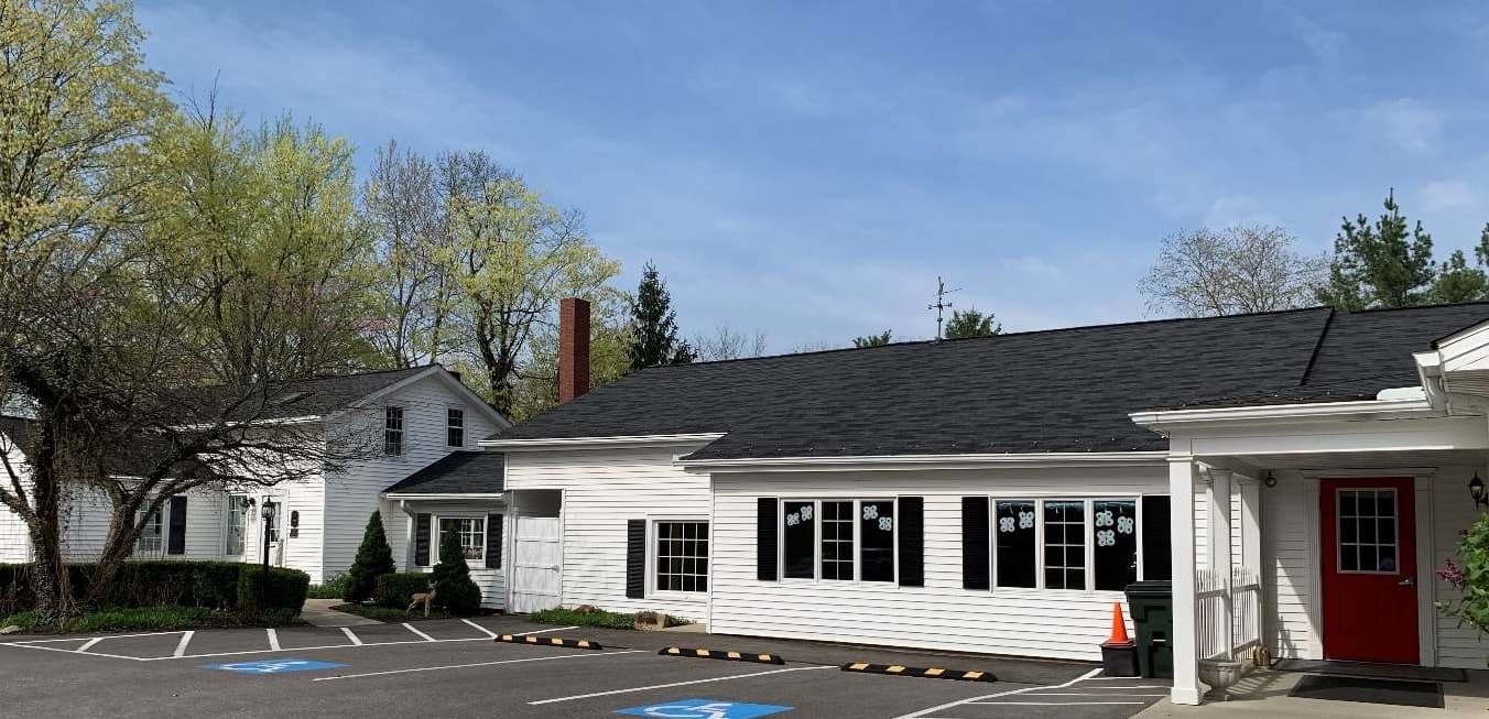 Exterior of the Young Explorers school, a century-old home, welcoming families with warmth and charm.