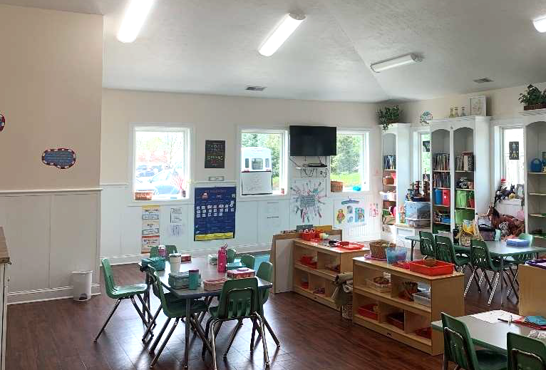 Preschool classroom with en-suite restrooms and built-in window seats and bookcases.